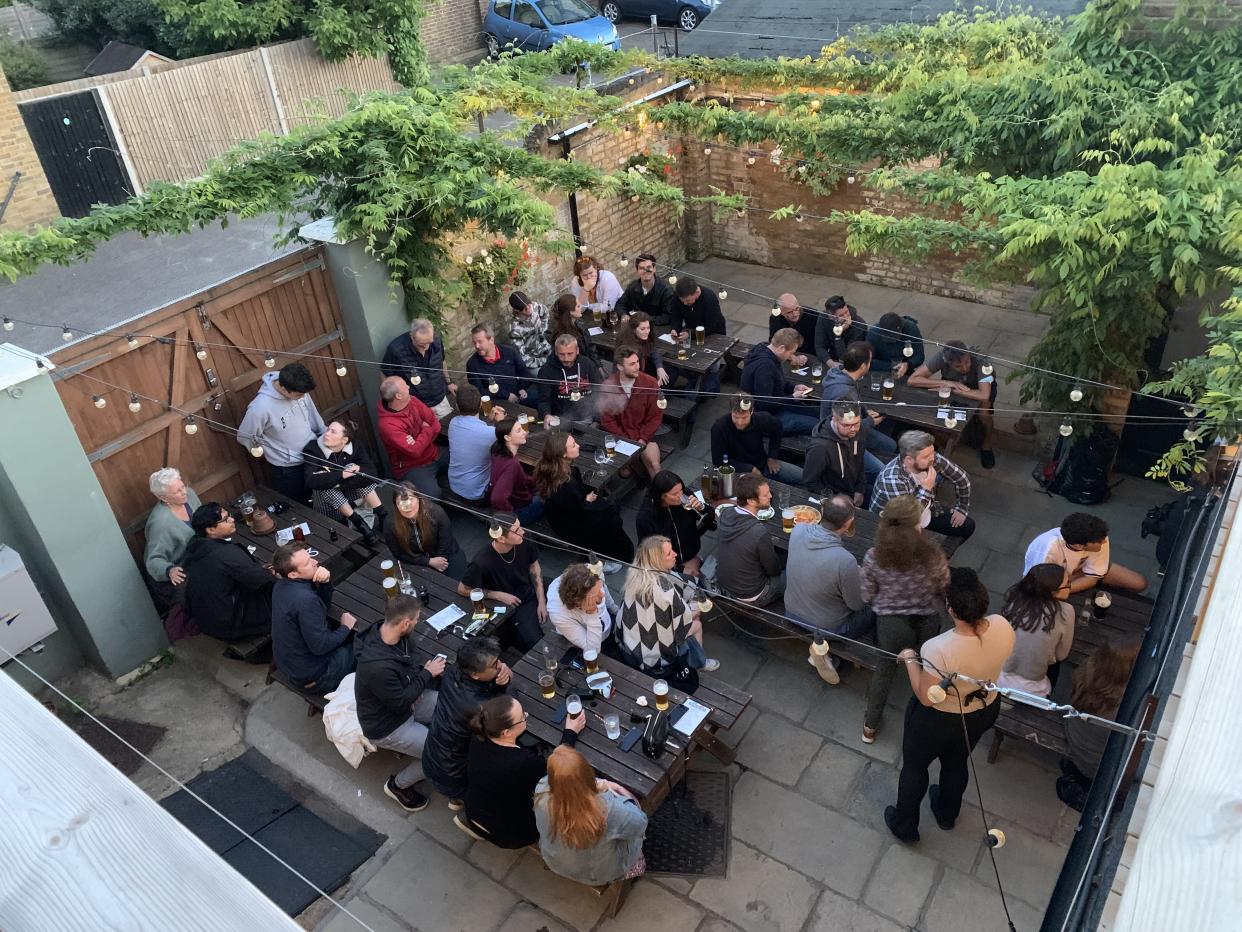 Customers sitting on benches at the Mitre pub