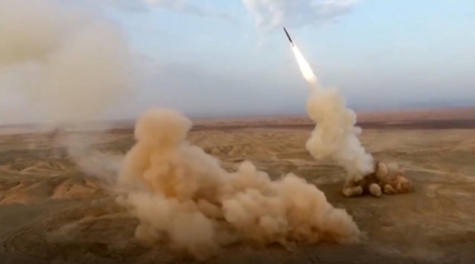This frame grab from video shows the launching of underground ballistic missiles by the Iranian Revolutionary Guard during a military exercise. Iran's paramilitary guard launched underground ballistic missiles as part of an exercise involving a mock-up aircraft carrier in the Strait of Hormuz, state television reported Wednesday. (Sepahnews via AP)