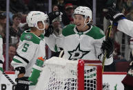 Dallas Stars' Andrej Sekera (5) celebrates with Jason Robertson (21) after Robertson's goal against the Arizona Coyotes during the second period of an NHL hockey game Saturday, Nov. 27, 2021, in Glendale, Ariz. (AP Photo/Darryl Webb)