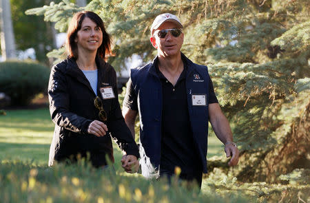 FILE PHOTO: Amazon CEO Jeff Bezos (R) and MacKenzie Bezos arrive at the annual Allen and Co. conference at the Sun Valley, Idaho Resort July 12, 2013. REUTERS/Rick Wilking/File Photo