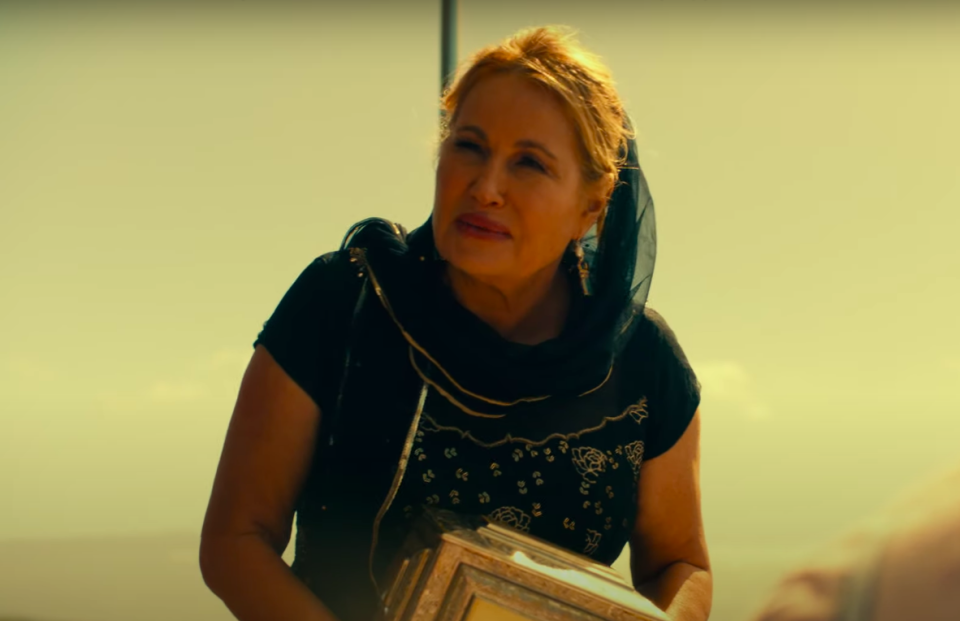 standing the boat, Tanya holds a box of her mother's ashes, ready to spread them at sea