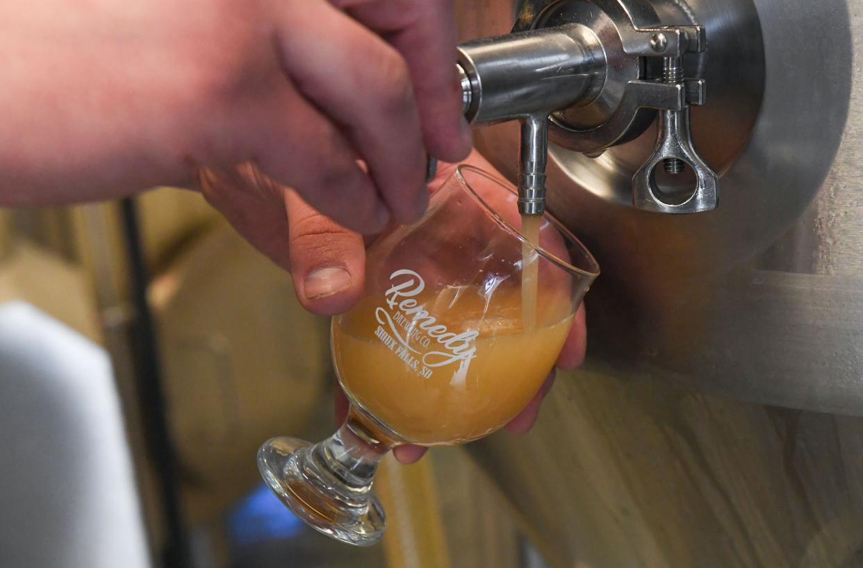 Tyler Wasberg pulls a sample of beer brewed with surface water from the Big Sioux River to check on the fermentation process on Wednesday, April 14, 2021, at Remedy Brewing Co. in Sioux Falls. The beer's consistency will change as fermentation continues and carbon dioxide will be added at the end of the brewing process.