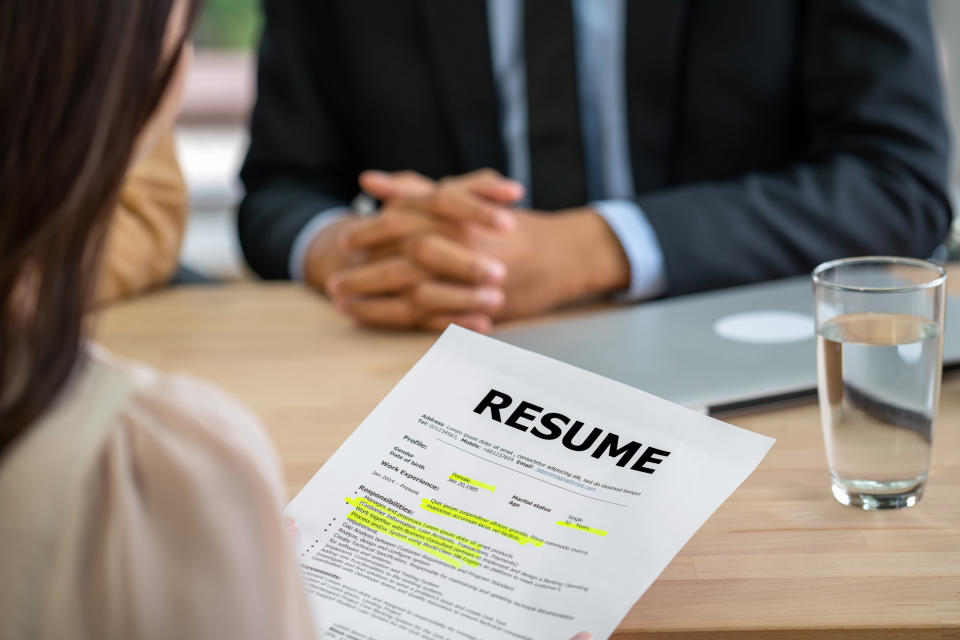 Closeup Young Asian woman graduate holding the resume document and preparing to two manager before start to job interview with positive motion in meeting room,Business Hiring new member concept