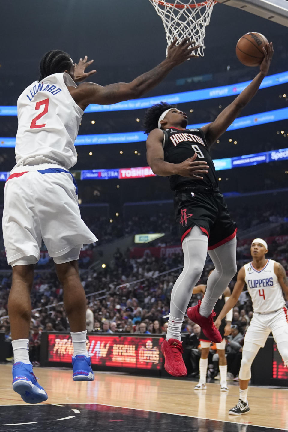 Houston Rockets guard Josh Christopher (9) scores past Los Angeles Clippers forward Kawhi Leonard (2) during the first half of an NBA basketball game Sunday, Jan. 15, 2023, in Los Angeles. (AP Photo/Marcio Jose Sanchez)