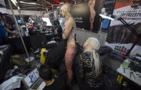 <p>A young woman has her body tattooed at the London Tattoo convention at Tobacco Dock on Sept. 23, 2017 in London, England. (Photo: James D. Morgan/Getty Images) </p>