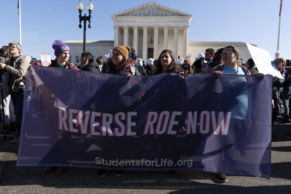 FILE - Anti-abortion protesters demonstrate in front of the U.S. Supreme Court Wednesday, Dec. 1, 2021, in Washington, as the court hears arguments in a case from Mississippi, where a 2018 law would ban abortions after 15 weeks of pregnancy, well before viability. An expected decision by the U.S. Supreme Court in the coming year to severely restrict abortion rights or overturn Roe v. Wade entirely is setting off a renewed round of abortion battles in state legislatures. (AP Photo/Jose Luis Magana)