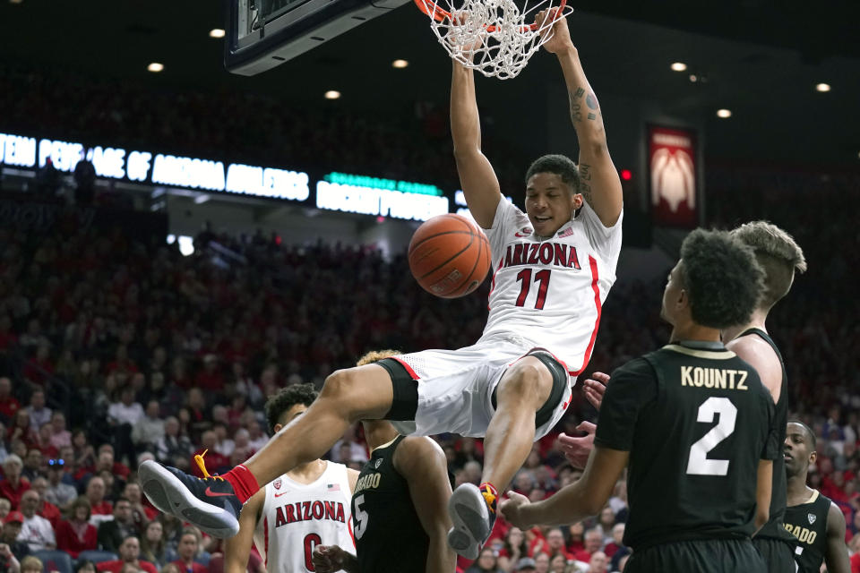 Arizona forward Ira Lee (11) dunks over Colorado guard D'Shawn Schwartz (5) and Daylen Kountz during the second half of an NCAA college basketball game Saturday, Jan. 18, 2020, in Tucson, Ariz. Arizona won 75-54. (AP Photo/Rick Scuteri)