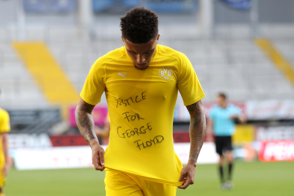 PADERBORN, GERMANY - MAY 31: Jadon Sancho of Borussia Dortmund celebrates scoring his teams second goal of the game with a 'Justice for George Floyd' shirt during the Bundesliga match between SC Paderborn 07 and Borussia Dortmund at Benteler Arena on May 31, 2020 in Paderborn, Germany. (Photo by Lars Baron/Getty Images)