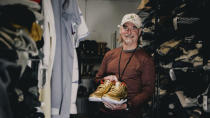 This photo provided by the Portland Rescue Mission shows James Free posing for a photo with a pair of of gold Nike Air Jordan 3 sneakers at the Portland Rescue Mission on Sunday, Oct. 30, 2023, in Portland, Ore. A pair of rare Nike sneakers donated to a homeless shelter in Portland, Oregon, are up for auction and are expected to raise as much as $20,000. Why? They were custom-made for filmmaker Spike Lee. (Aaron Ankrom/Portland Rescue Mission via AP)