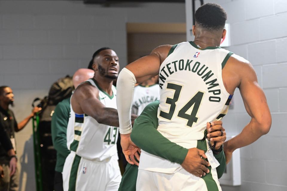 Dec 13, 2023; Milwaukee, Wisconsin, USA; Milwaukee Bucks forward Giannis Antetokounmpo (34) is restrained by a coach outside the Indiana Pacers locker room after the game at Fiserv Forum. Mandatory Credit: Benny Sieu-USA TODAY Sports