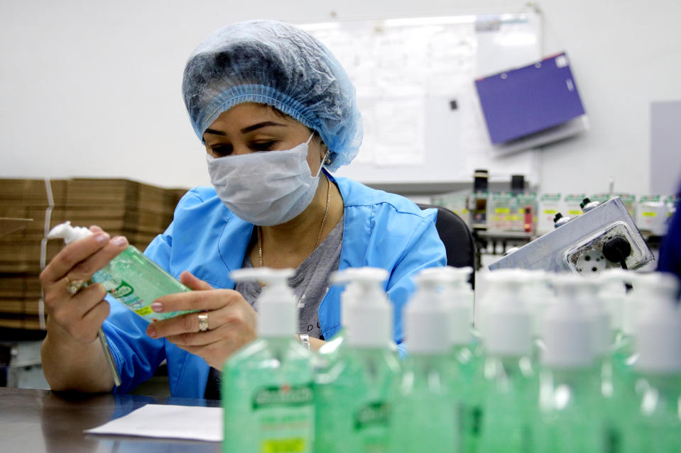 MOSCOW, RUSSIA - MARCH 23, 2020: An employee ahead of packaging bottles of Sanitelle hand sanitizer at a Bentus Laboratories plant. Sergei Bobylev/TASS (Photo by Sergei Bobylev\TASS via Getty Images)