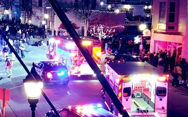 Police and ambulance at the scene in Waukesha, Wisconsin, where a car has crashed into a crowd - Twitter