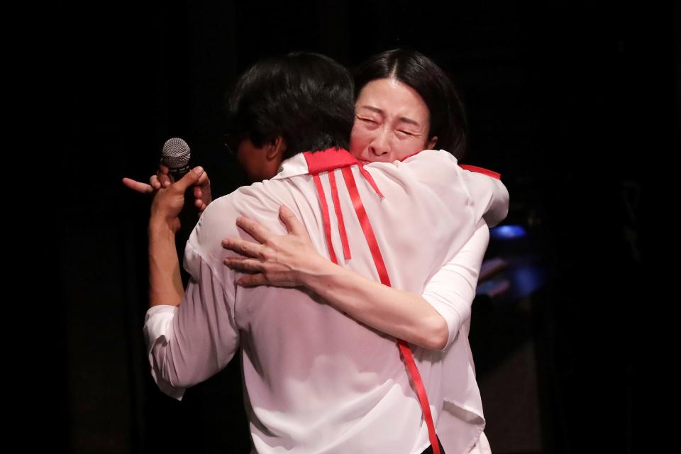 Joori Jung, 40, of Troy, embraces her student Luca Nixon, who has been dancing with her for four years and is now leaving for college, before his last performance with Artlab J at the end-of-season dance recital at Marygrove Theatre in Detroit on June 9, 2023. Jung says she was overwhelmed with emotion and gratitude thinking about how much Nixon has grown in life and in dance over the years while at Artlab J.