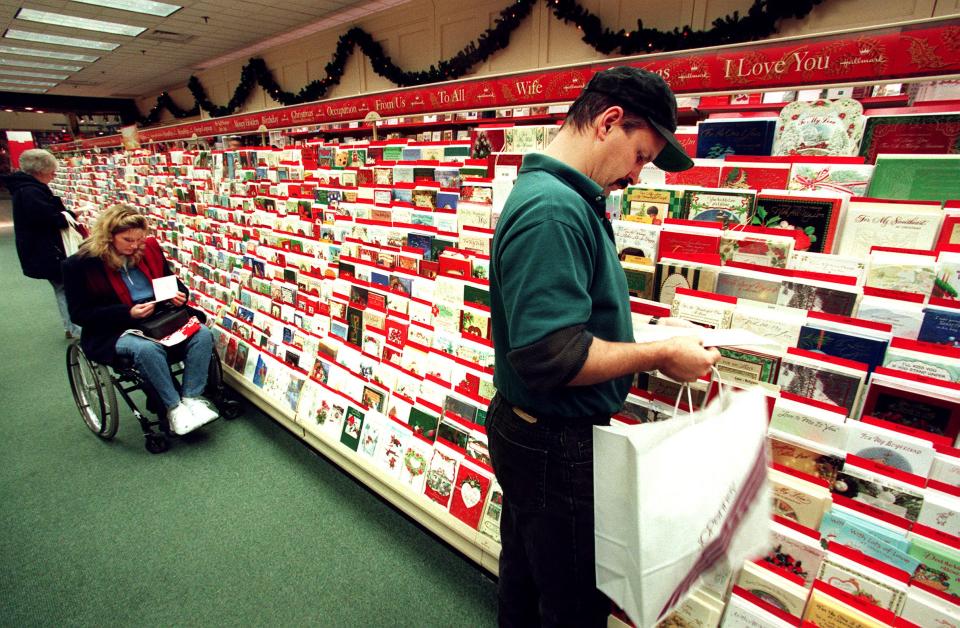 Customers shop for Christmas cards in the Hallmark Crown Shop in Eastland Mall, Columbus.
