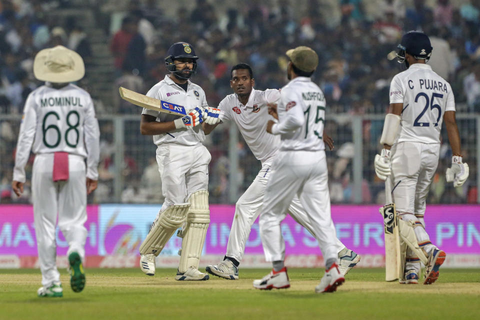 Bangladesh's cricketers celebrate the dismissal of India's Rohit Sharma, second left, during the first day of the second test match between India and Bangladesh in Kolkata, India, Friday, Nov. 22, 2019. (AP Photo/Bikas Das)