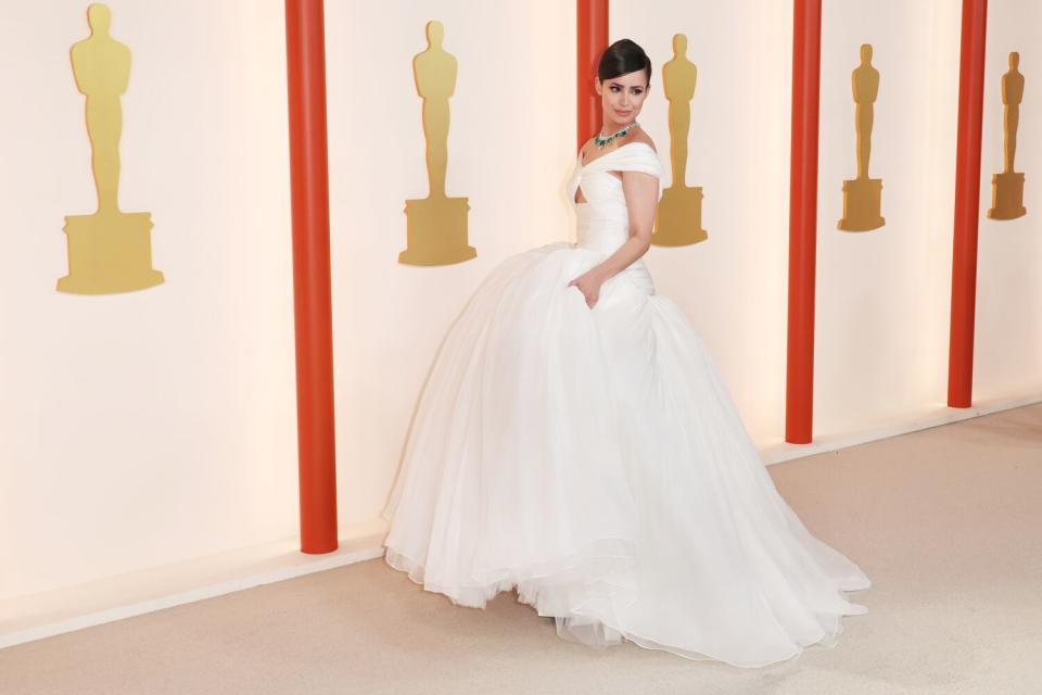 Sofia Carson in a white gown with a fluffy, tulle bottom.