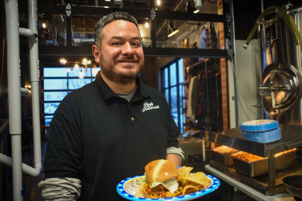 Rudy Navarrete holding his "The Spice is Right" burger on Thursday, Jan. 25, 2024 at Severance Brewing Company in Sioux Falls.