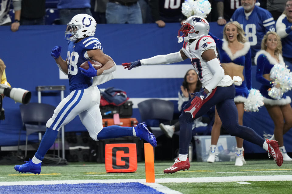 Indianapolis Colts running back Jonathan Taylor (28) scores past New England Patriots cornerback J.C. Jackson (27) for a 67-yard touchdown during the second half of an NFL football game Saturday, Dec. 18, 2021, in Indianapolis. (AP Photo/AJ Mast)