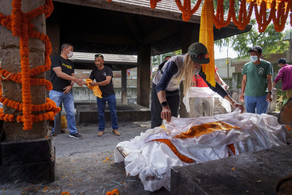 Friends and family members pay their last tributes during the funeral of famed American extreme skier Hilaree Nelson in Kathmandu, Nepal, Sunday, Oct.2, 2022. Nelson had died last week on Mount Manaslu while coming down from the top of the summit the 8,163-meter (26,775-foot) world's eighth-highest mountain. (AP Photo/Niranjan Shrestha)