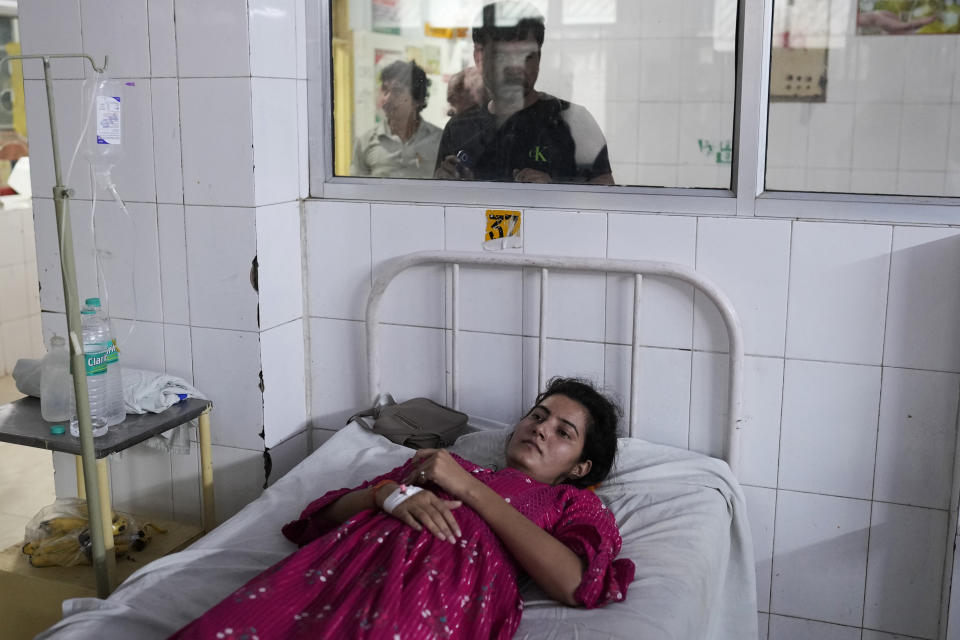 Neelam Tamar, 25, suffering from heat stroke, recovers at the Lalitpur district hospital, in Indian state of Uttar Pradesh, Saturday, June 17, 2023. Extreme heat is fast becoming a serious public health crisis in India. (AP Photo/Rajesh Kumar Singh)