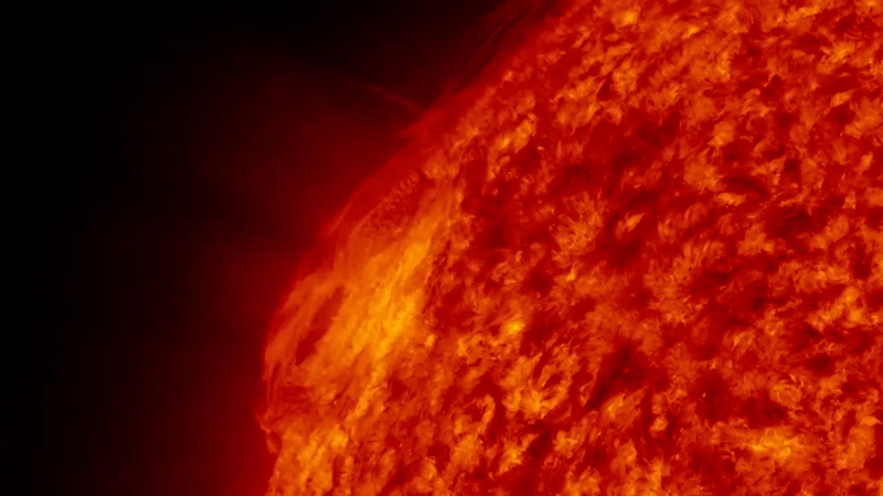  Gif animation showing a large fiery eruption from the sun, it launches up into a fiery arch shape. . 
