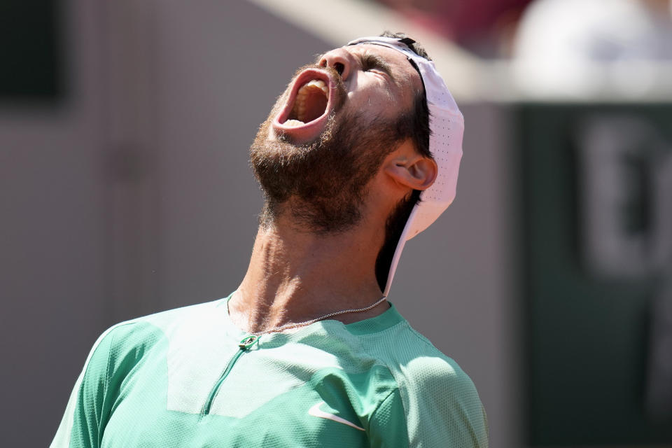 Russia's Karen Khachanov celebrates winning his fourth round match of the French Open tennis tournament against Italy's Lorenzo Sonego, at the Roland Garros stadium in Paris, Sunday, June 4, 2023. (AP Photo/Christophe Ena)