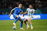 Italy's Barbara Bonansea, left, and Argentina's Florencia Bonsegundo vie for the ball during the Women's World Cup Group G soccer match between Italy and Argentina at Eden Park in Auckland, New Zealand, Monday, July 24, 2023. (AP Photo/Abbie Parr)