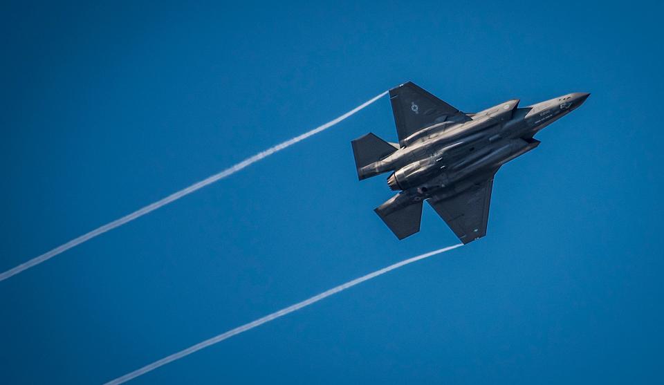 An F-35 Lightning II streaks across the sky while doing maneuvers to the Eglin Air Force Base runway.