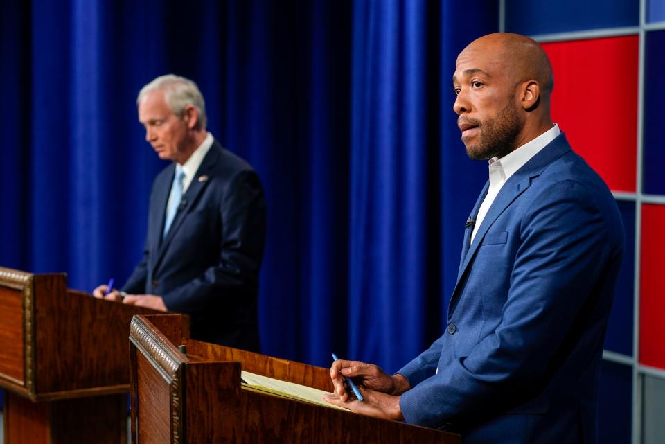 U.S. Sen. Ron Johnson, R-Wis., left, and his Democratic challenger Mandela Barnes wait for start of a televised debate, Friday, Oct. 7, 2022, in Milwaukee.