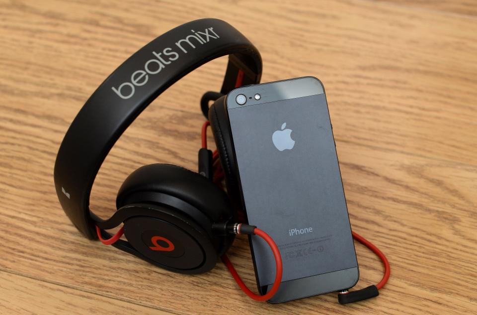 General view of a pair of beats Mixr headphones alongside an Apple iPhone 5, as Apple will make the most expensive acquisition in its history, after confirming a deal to buy Dr Dre's Beats Electronics for 3 billion dollars (£1.78 billion).   (Photo by Andrew Matthews/PA Images via Getty Images)