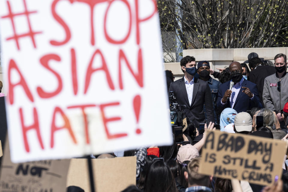 FILE - This March 20, 2021, file photo shows, U.S. Sens. Jon Ossoff, D-Ga., and Raphael Warnock, D-Ga., speaking during a "stop Asian hate" rally outside the Georgia State Capitol in Atlanta. A national coalition of civil rights groups will release on Wednesday, July 28, 2021, a comprehensive, state-by-state review of hate crime laws in the United States. Members of the coalition say the report sets the stage for bolstering the efficacy of current law and addresses racial disparities in how the laws are enforced. (AP Photo/Ben Gray, File)