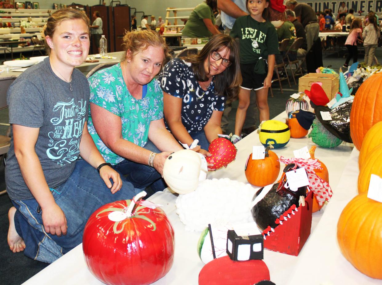 Volunteers Carissa Bahner, Carrie Croner and Amy Brant check-in decorated pumpkins and gourds during entry day Wednesday at the Berlin Brothersvalley Community Fair.
