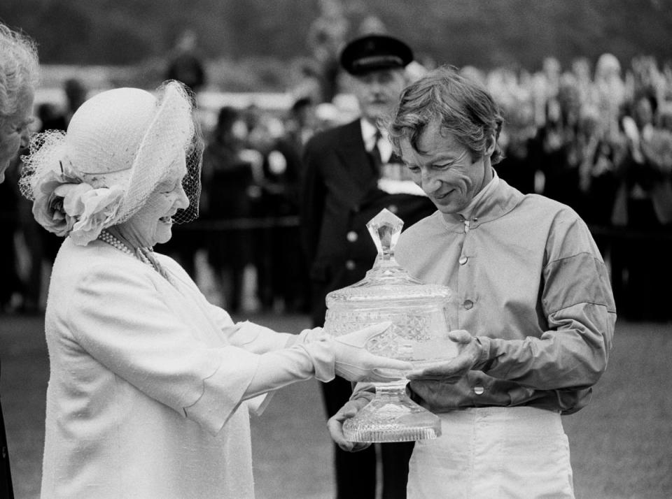 Lester Piggott receiving the Ritz Club trophy from the Queen Mother in 1981 (PA)