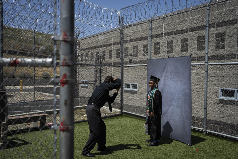 Incarcerated graduate Jose Catalan poses for photos after his graduation ceremony at Folsom State Prison in Folsom, Calif., on May 25, 2023. Catalan earned his bachelor's degree in communications through the Transforming Outcomes Project at Sacramento State University. (AP Photo/Jae C. Hong)