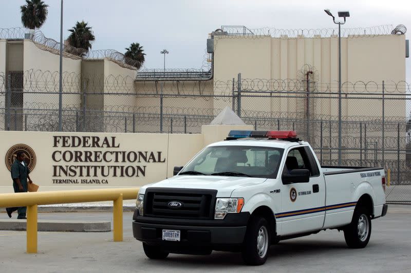 FILE PHOTO: A guard drives past the entrance of the Federal Correctional Institution where former Ukraine Prime Minister Pavlo Lazarenko was released from custody in San Pedro