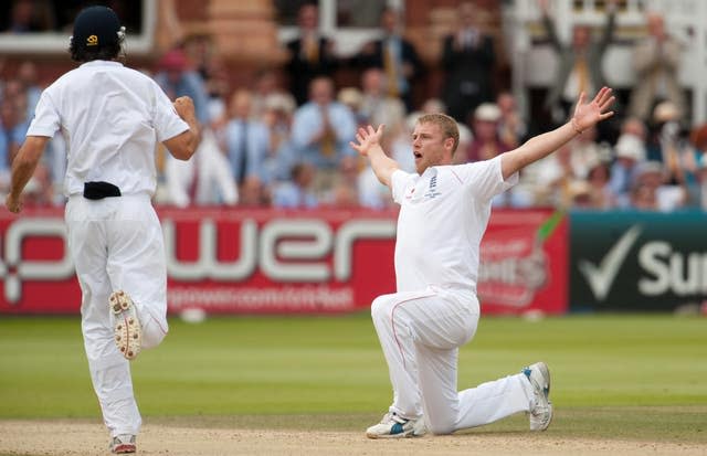 Andrew Flintoff kneels and stretches his arms out in celebration after taking a wicket for England