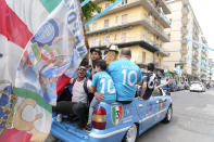 Napoli fans celebrate outside the Diego Maradona stadium in Naples, Italy, Sunday, April 30, 2023. After Napoli's game was moved to Sunday, the team could secure the title in front of their own fans by beating Salernitana — if Lazio fails to win at Inter Milan earlier in the day. Diego Maradona led Napoli to its only previous Serie A titles in 1987 and 1990. (AP Photo/Gregorio Borgia)