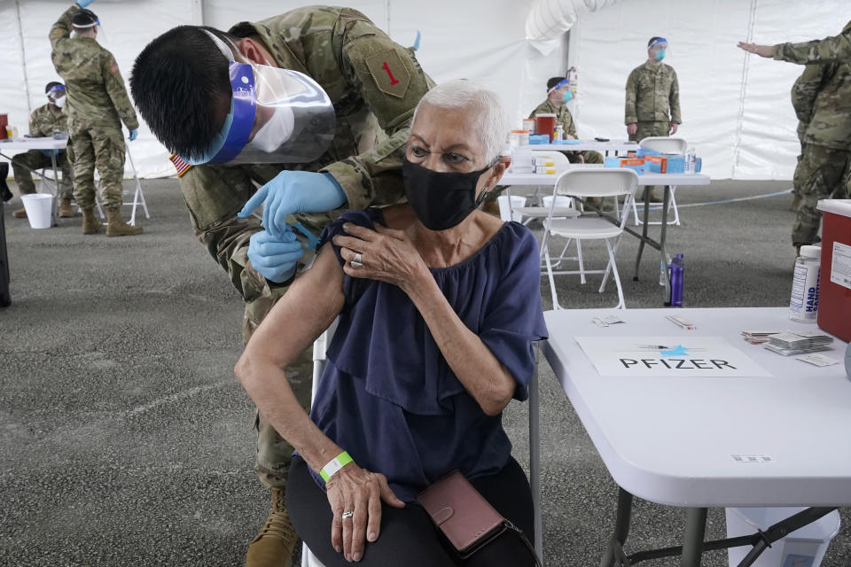 Ivonne Burgess, 81, gets the first dose of the Pfizer COVID-19 vaccine at a FEMA vaccination site at Miami-Dade College, Wednesday, March 3, 2021, in North Miami, Fla. This is one of four FEMA sites in Florida that opened Wednesday with capacity to vaccinate up to 3,000 people a day, seven days a week. (AP Photo/Marta Lavandier)