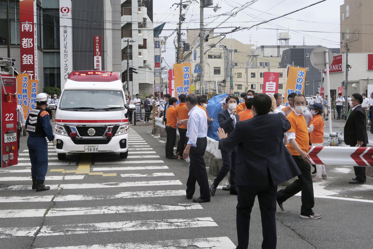 People react after gunshots in Nara, western Japan Friday, July 8, 2022. Japan’s former Prime Minister Shinzo Abe was in heart failure after apparently being shot during a campaign speech Friday in western Japan, NHK public television said Friday. (Kyodo News via AP)