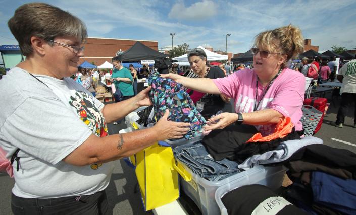 Angela Gady, with Hope Dealers, shows colorful clothing to Deborah Threatt during Hope Fest held Thursday, June 30, 2022, at First United Methodist Church of Gastonia on East Franklin Boulevard.