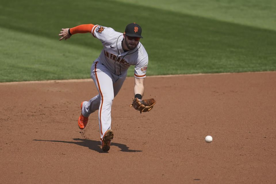 San Francisco Giants third baseman Evan Longoria fields Oakland Athletics' Mark Canha's groundout during the first inning of a baseball game in Oakland, Calif., Sunday, Sept. 20, 2020. (AP Photo/Jeff Chiu)