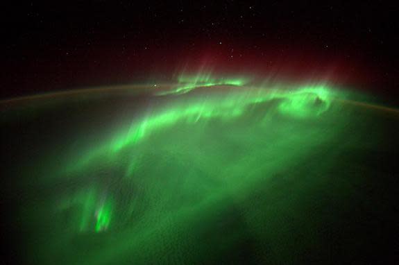 The northern lights dance over Earth in shimmering green light on Aug. 29, 2014 in this amazing photo by European Space Agency astronaut Alexander Gerst on the International Space Station. Recent solar storms on Sept. 8 and 10 may amplify Earth
