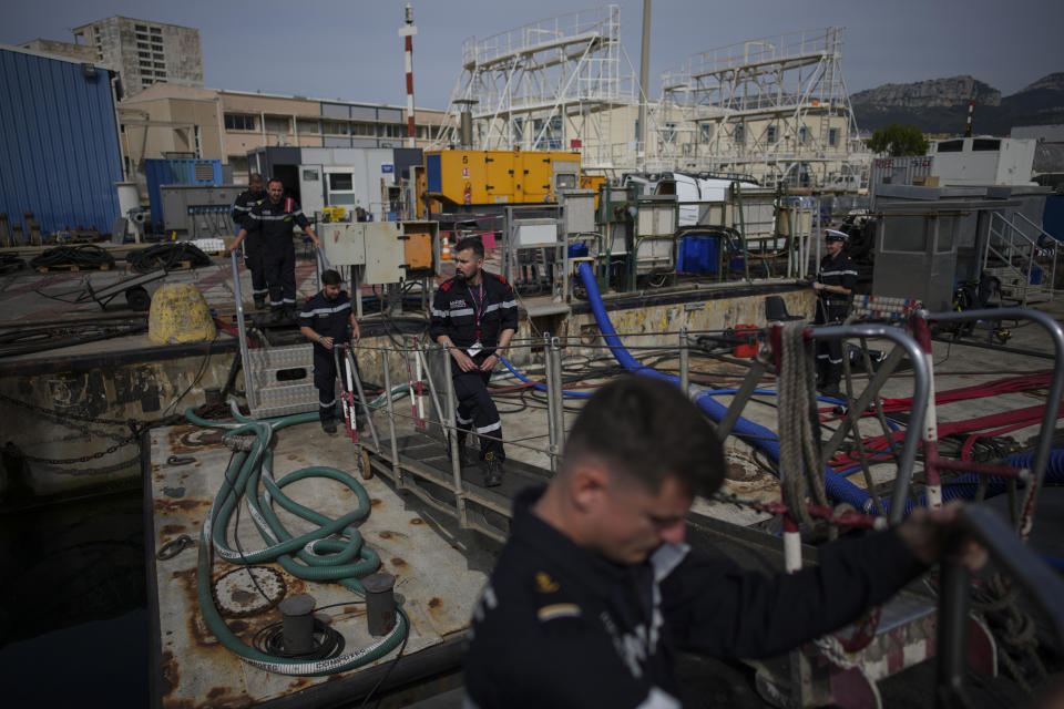 Sailors prepare a French Rubis-class submarine at the Toulon naval base in southern France, Monday, April 15, 2024. The nuclear powered submarine will be guarding France's Charles de Gaulle aircraft carrier during training exercises dubbed Neptune Strike in the Mediterranean with the 32-nation NATO military alliance. (AP Photo/Daniel Cole)