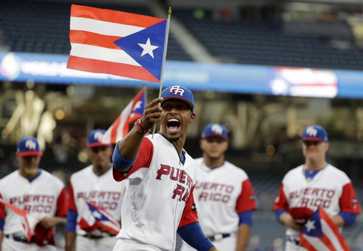 Puerto Rico infielder Francisco Lindor, right, yells after he tagged out  Nicaragua's Juan Diego Montes (99) as Montes tried to steal the second base  during the fourth inning of a World Baseball