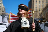 <p>A woman dressed as Lady Justice participants in the “Mock Funeral for Presidents’ Day” rally at Washington Square Park in New York City on Feb. 18, 2017. (Gordon Donovan/Yahoo News) </p>