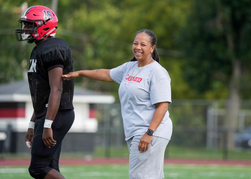 Des Moines East assistant coach Renate Rice helps get her players ready during a preseason practice earlier this month