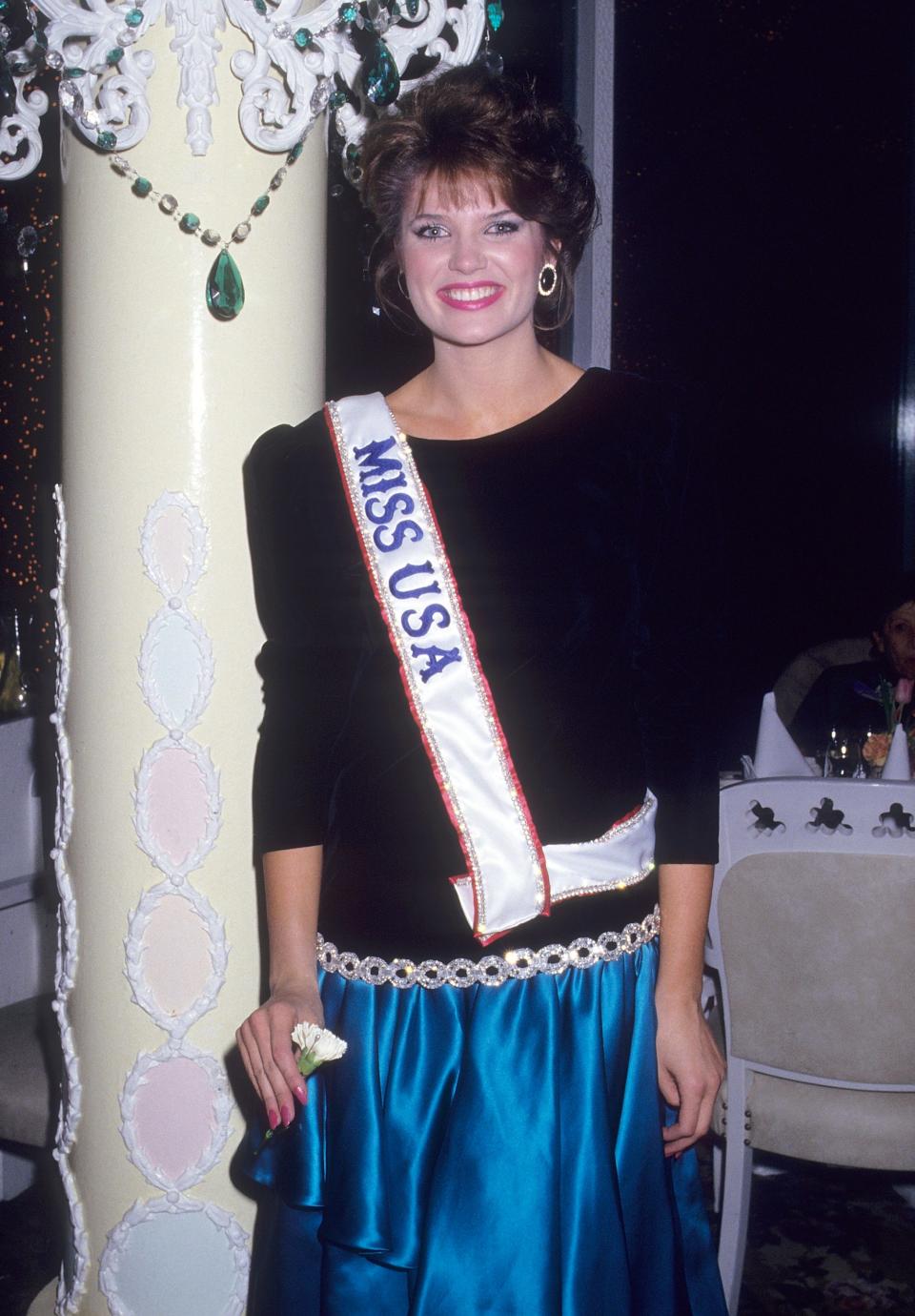 Miss USA 1987 Michelle Royer smiles wearing her sash.