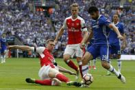 Arsenal's Per Mertesacker (L) slides in to tackle Chelsea's Diego Costa during their English FA Cup final at Wembley stadium in London on May 27, 2017