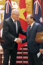 Australian Prime Minister Scott Morrison, left, and his Vietnamese counterpart Nguyen Xuan Phuc shake hands during a press briefing at the Government Office in Hanoi, Vietnam, Friday, Aug. 23, 2019. (AP Photo/Duc Thanh)