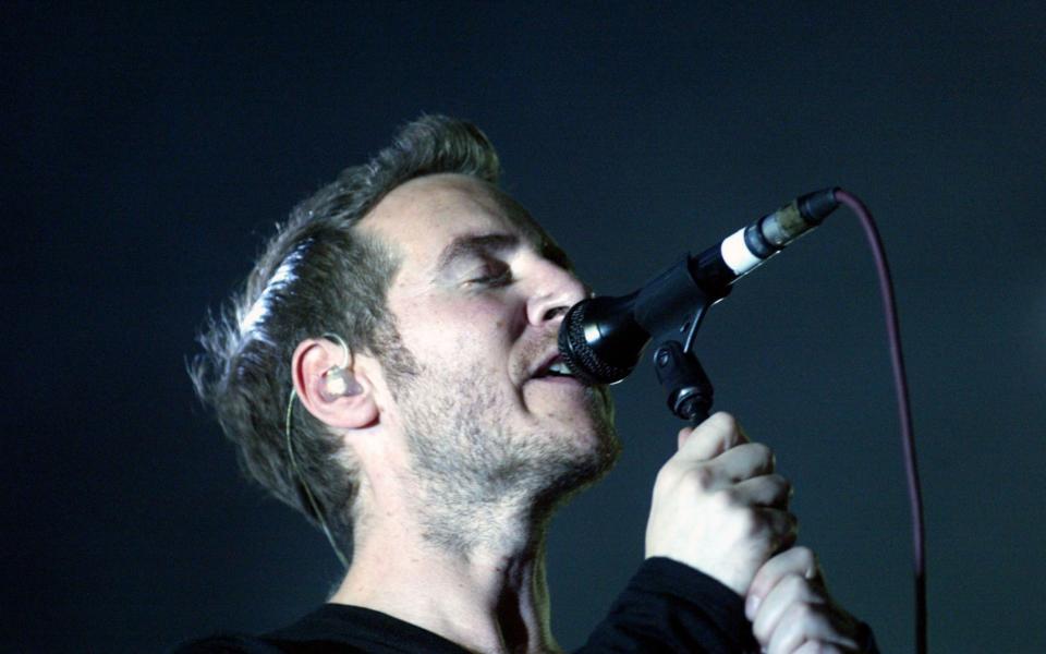 Robert Del Naja of the British group Massive Attack performs to a crowd of approximately 10,000 at Queens Square August 25, 2003 in Bristol - Credit: Getty